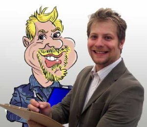 Caricaturist David With a Clip Board in Hand Stands in Front of a Self Portrait Drawn in a Cartoon Style