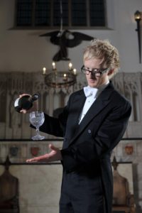 Magician Performs The Floating Wine Glass Illusion Dressed In A Formal Tail Coat