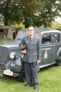 Gary Richard Singer War Time Singalong In Military Uniform Standing In Front Of A Military Vehicle