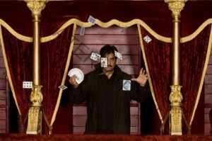 Shahid Malik, magician, at the City Varieties Music Hall in Leeds scattering playing cards from one of the ornate red and gold theatre balconies.