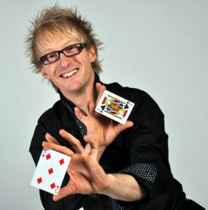 Close Up Magician Sonic Displays The Five Of Diamonds And The Jack Of Clubs Playing Cards In His Hands