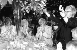 Guests Applauding And Smiling As Magician Sonic Performs Close Up Table Magic At A Corporate Event In London