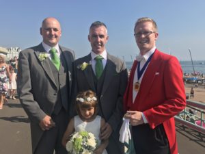 Toastmaster Dan in Full Red Coat Uniform With Newly Wed Husbands on Brighton Sea Front