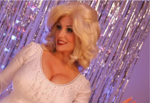 Dolly Parton Tribute Act Singing Live Against A Glitter Slash Curtain