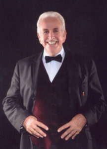 Don Maclean Comedian Suited and Booted Hands In Bergundy Waistcoat