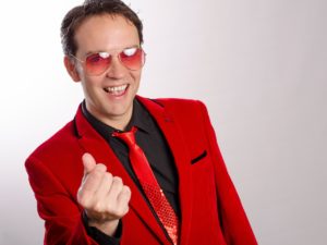 Cliff Richard Tribute Act Wearing a Red Suit And Red Sunglasses