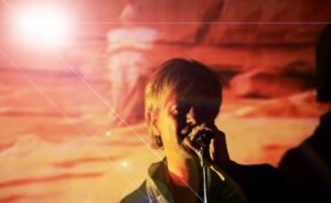 David Bowie Tribute In Orange Light With Projected Bowie Background