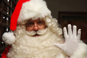 Santa Claus Father Christmas With A Long White Beard And White Gloves, Smiling And Waving