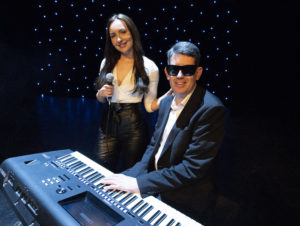 Cool Hands Duo Looking Cool Posing At The Electric Piano