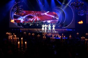 Siren Electric Violin Quartet Performing Live In A Large Corporate Venue Decorated With Candle Lit Tables