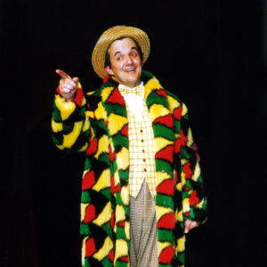 Richard Comedy Master Of Ceremonies In Long Multicoloured Comedy Coat