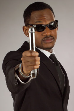 Will Smith Lookalike Wearing A Men In Black Suit Holding Memory Eraser Gizmo