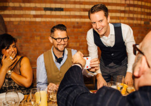 Christopher Close Up Magician Guests Smiling And Laughing As Trick Is Performed