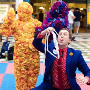 Magical Ritchie Childrens Entertainer Performs A Trick With Human Flower In The Background