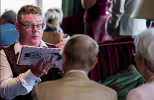 Steve Caricaturist Couple Photographed From Behind As Their Caricatures Are Drawn