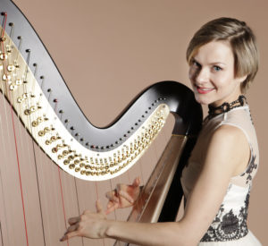 Alex Professional Harpist Against A Taupe Background