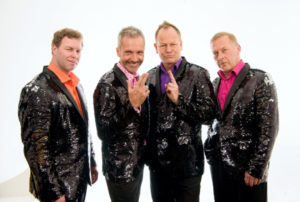 Four Poofs & A Piano With Black Glitter Jackets Against A White Background
