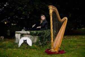 Harpist Fiona Seated Outdoors Golden Harp