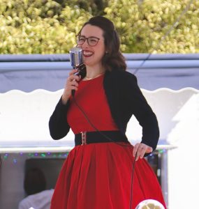 Vintage singer Mitzi Metford singing live at an open air vintage festival in Sussex
