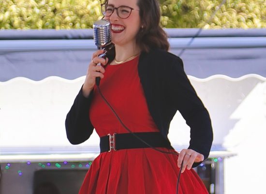 Vintage singer Mitzi Metford singing live at an open air vintage festival in Sussex